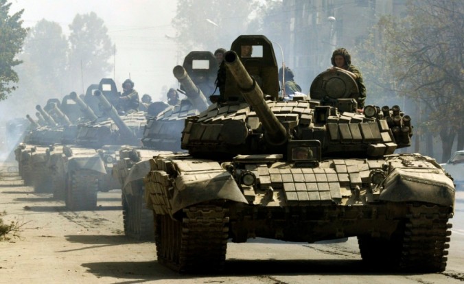 Russian tanks drive through Tskhinvali, the regional capital of Georgia's breakaway province of South Ossetia, moving to the Russian border, Saturday, Aug. 30, 2008. Georgia has severed diplomatic ties with Moscow to protest the presence of Russian troops on its territory, and its president cast the far-confrontation over his country's fate as "a fight between the civilized and the uncivilized worlds." (AP Photo/Dmitry Lovetsky)